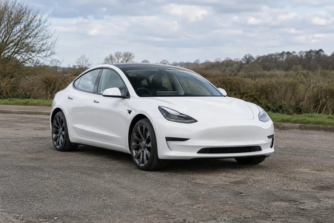 Illustration of a white electric car in a roadside layby
