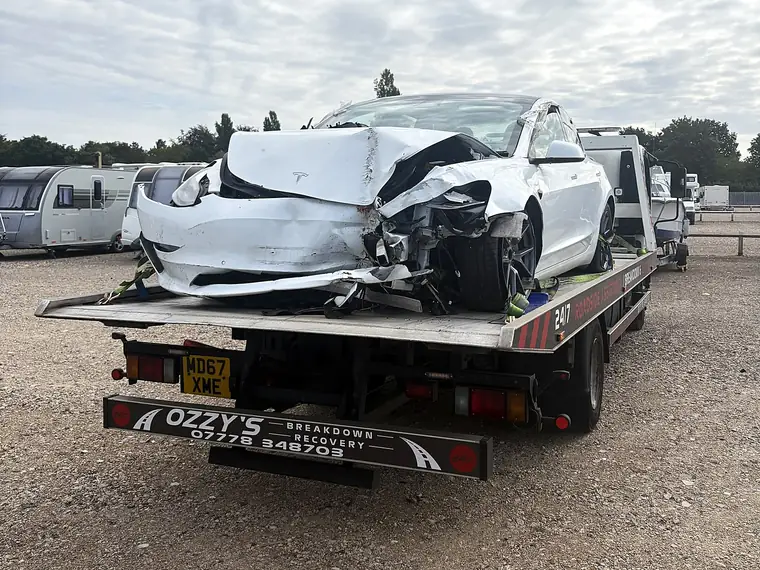 Accident-damaged Tesla loaded on Ozzy’s Breakdown Recovery truck